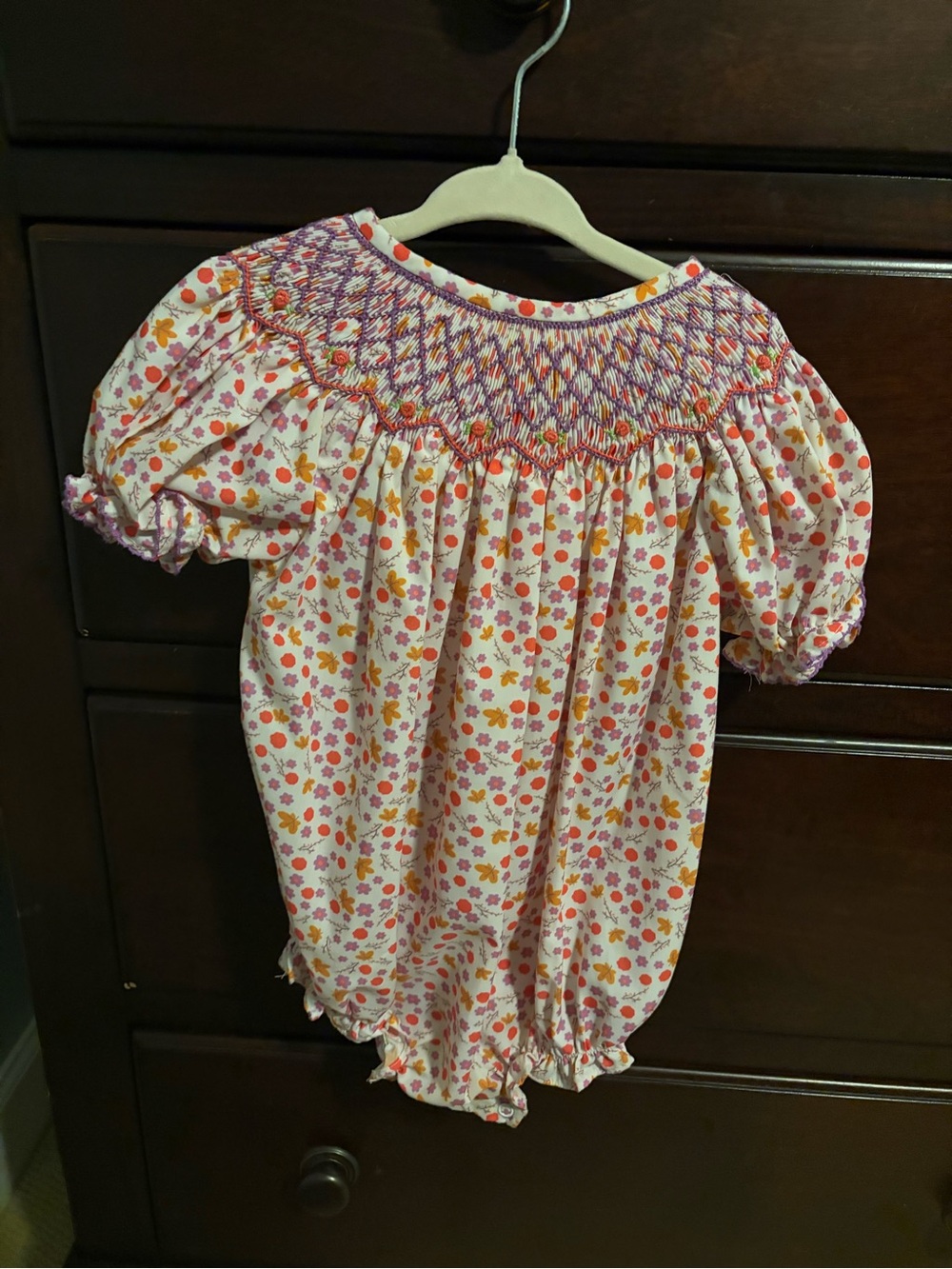 Purple Smocks Smocked Floral Bubble Romper in Pink, Orange and Yellow